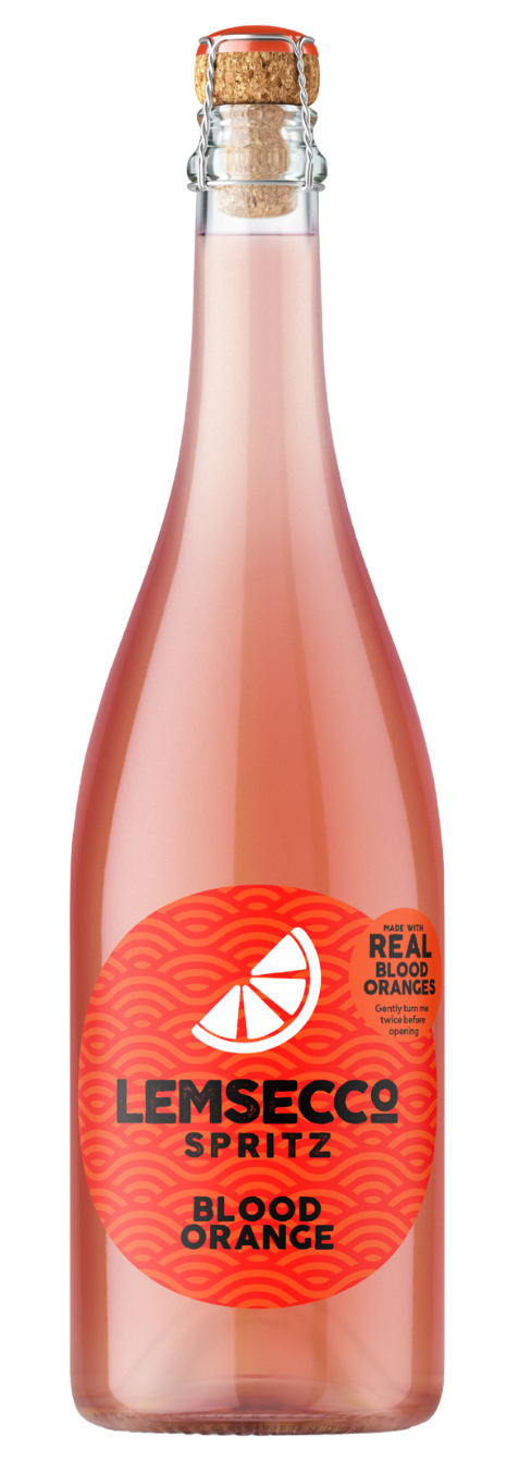 A clear glass bottle of Lemsecco Blood Orange Prosecco Spritz with a cork top features a pinkish-orange drink and a round red label with a citrus slice graphic and black text, highlighting this refreshing blood orange spritz.